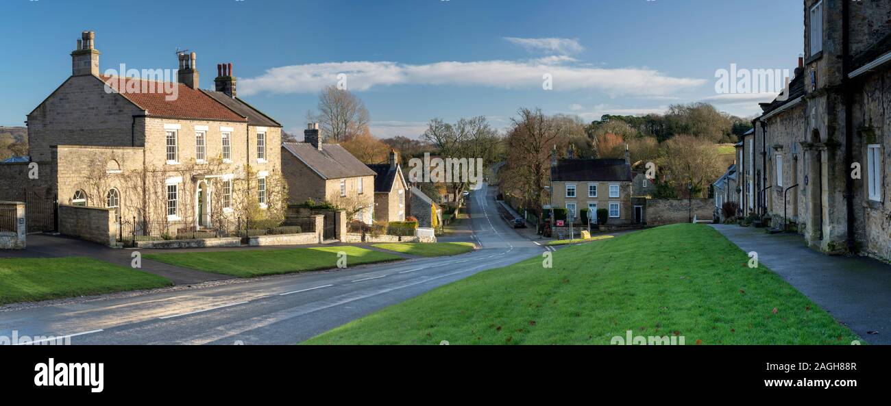 Panoramic view if stone cottages along Thirsk Bank, the main road through the North Yorkshire village of Coxwold Stock Photo