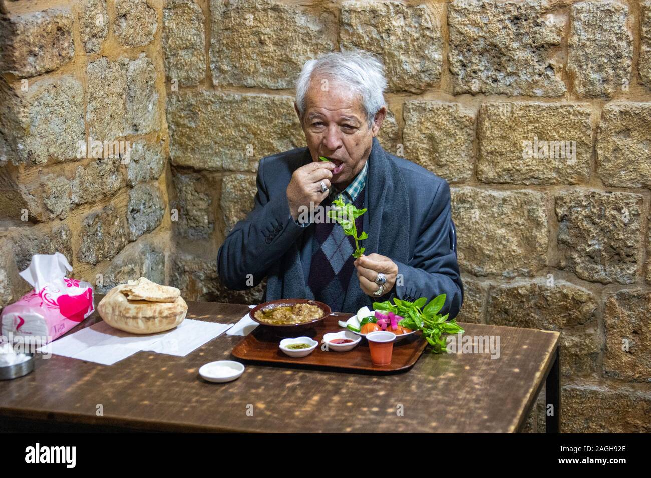 Local man eating foul, Souk Area, Tyre or Sour, Lebanon Stock Photo