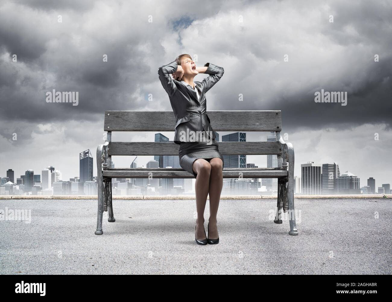 Stressful woman sitting on wooden bench Stock Photo
