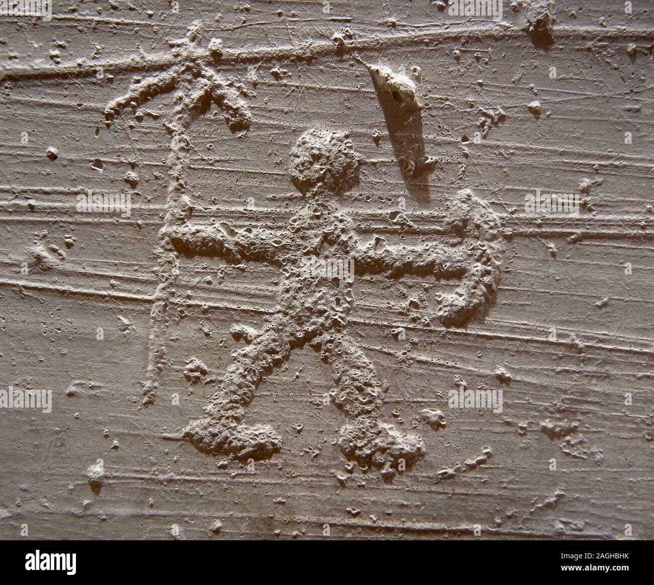 Cast of a prehistoric Petroglyph, rock carving, of a warrior with a spear and shield carved by the Camunni people in the iron age between 1000-1600 BC Stock Photo