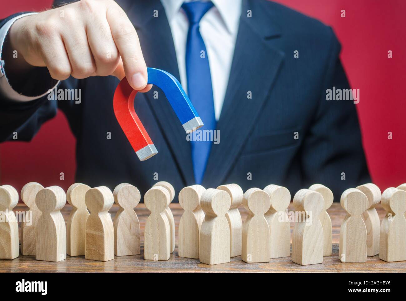 Businessman looking for new employees with a magnet. Search for professionals specialists for open vacancies. Recruiting talented workers, headhunters Stock Photo