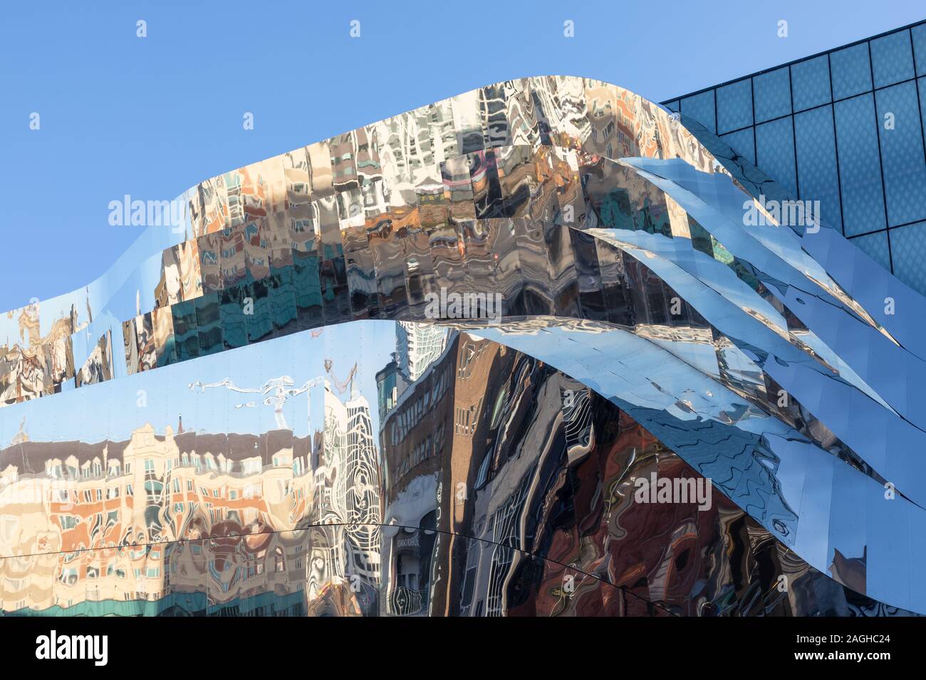 Birmingham, West Midlands, UK: Nearby buildings are reflected in the stainless steel cladding on the outside of Grand Central shopping centre. Stock Photo