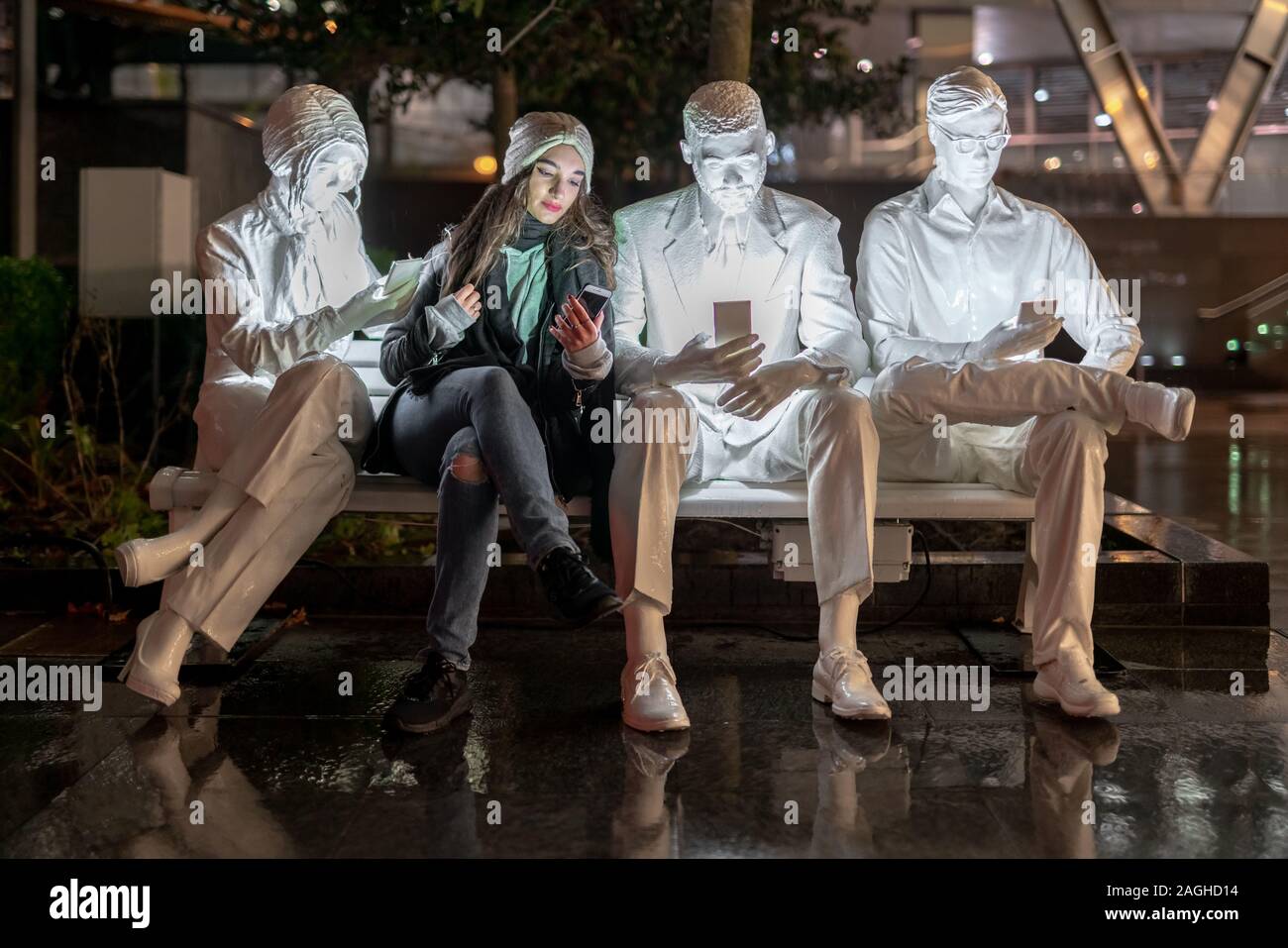 London, UK. 19th December, 2019. IlluminoCity exhibition by Light Art Collection. Student Rebecca, 20, models 'Absorbed by Light' installation by Gali May Lucas, part of IlluminoCity light exhibition in Principal Place, Shoreditch. Credit: Guy Corbishley/Alamy Live News Stock Photo