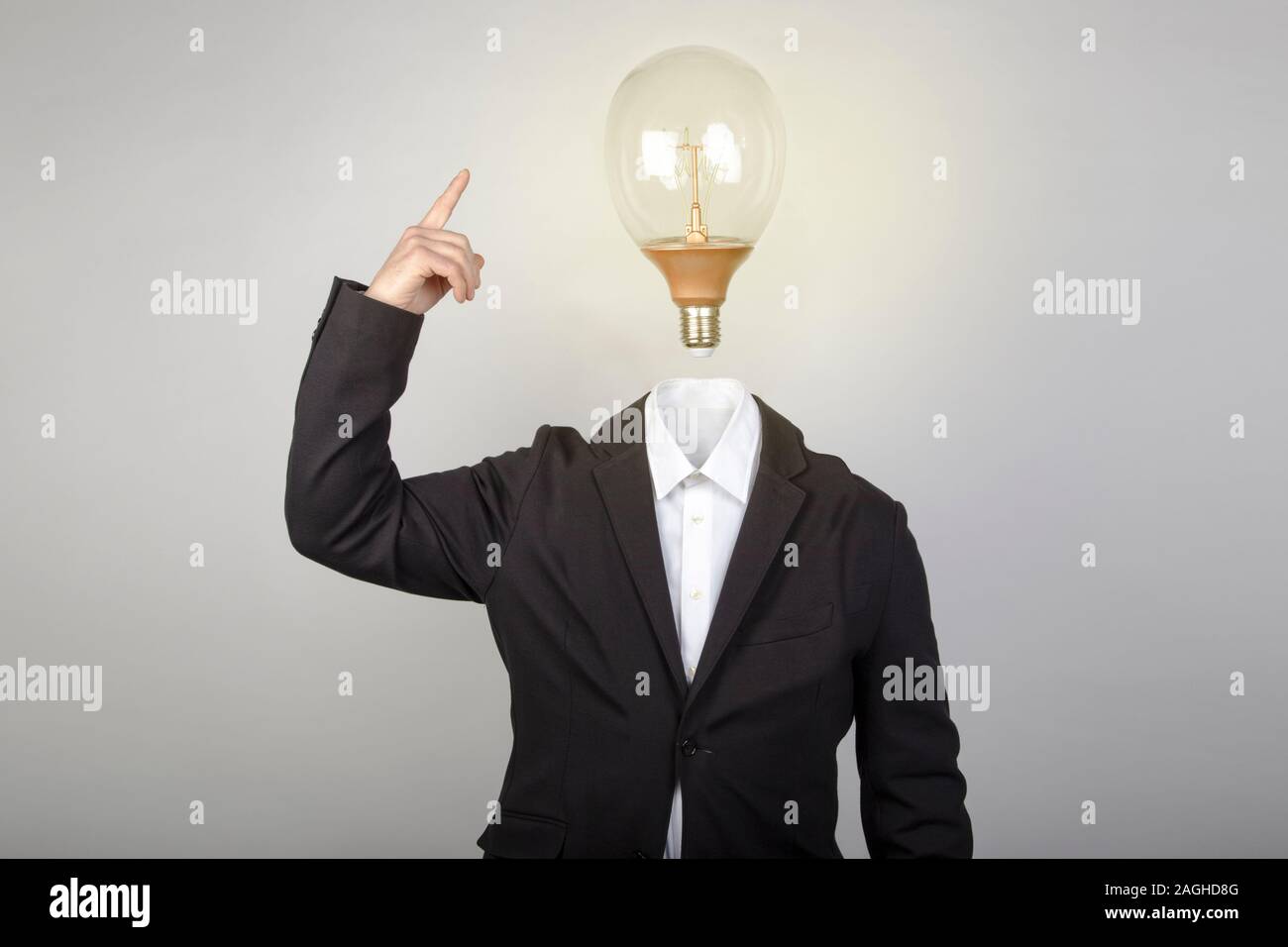 Headless businessman turns on the light bulb when having an idea