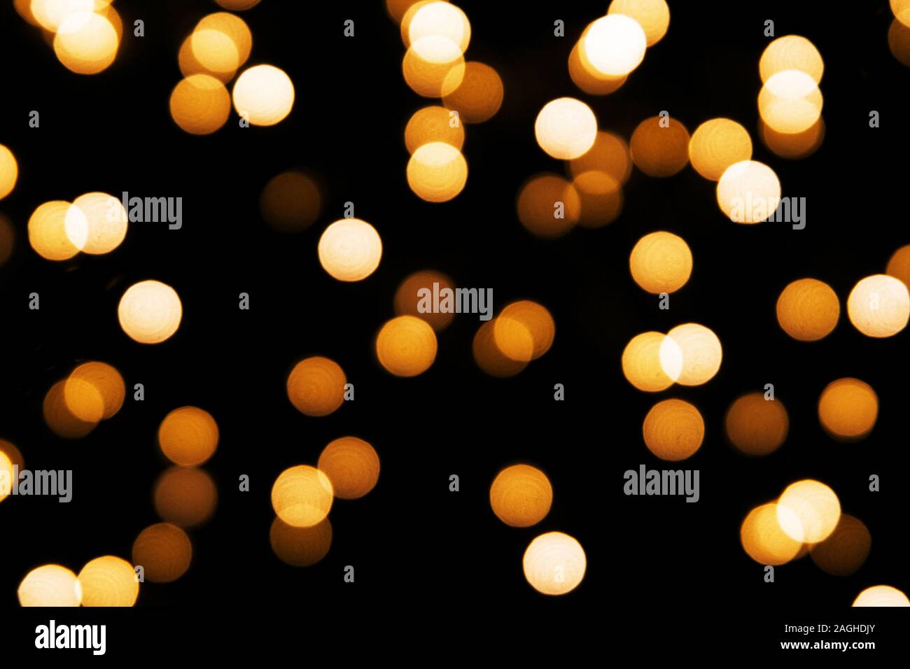 Abstract background with golden glitter light bokeh isolated on black ...