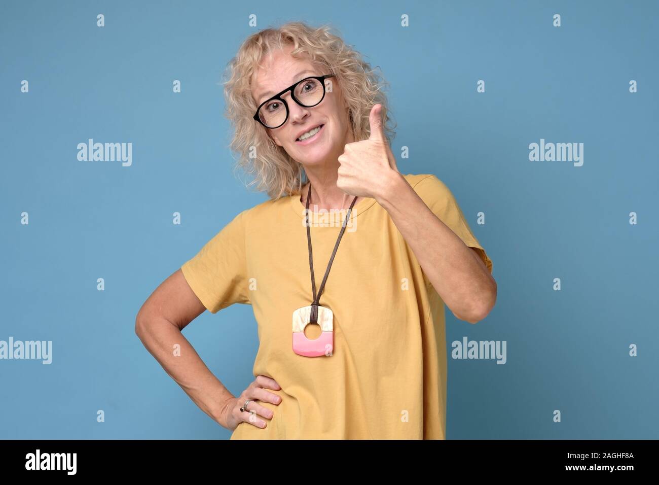 Beautiful senior woman showing thumbs up sign Stock Photo - Alamy