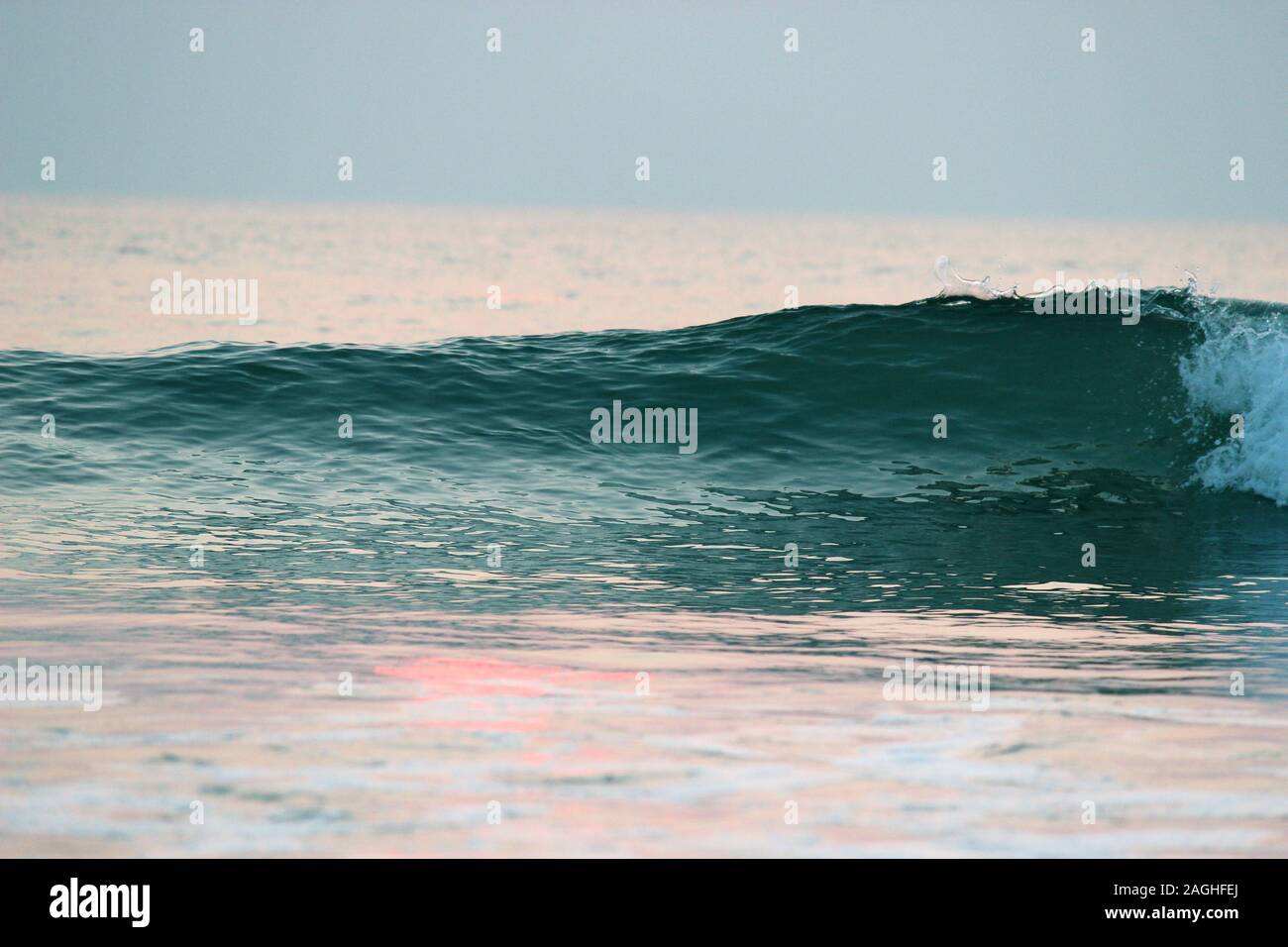Collapsing turquoise blue wave in arabian Sea beach goa india Stock Photo