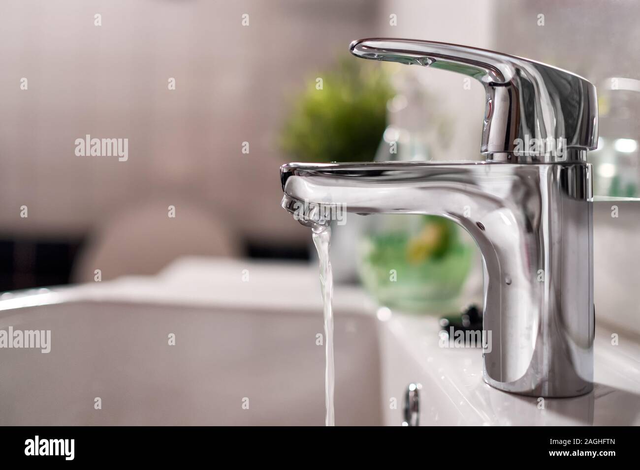 Cold water flowing from faucet in clean bathroom Stock Photo Alamy