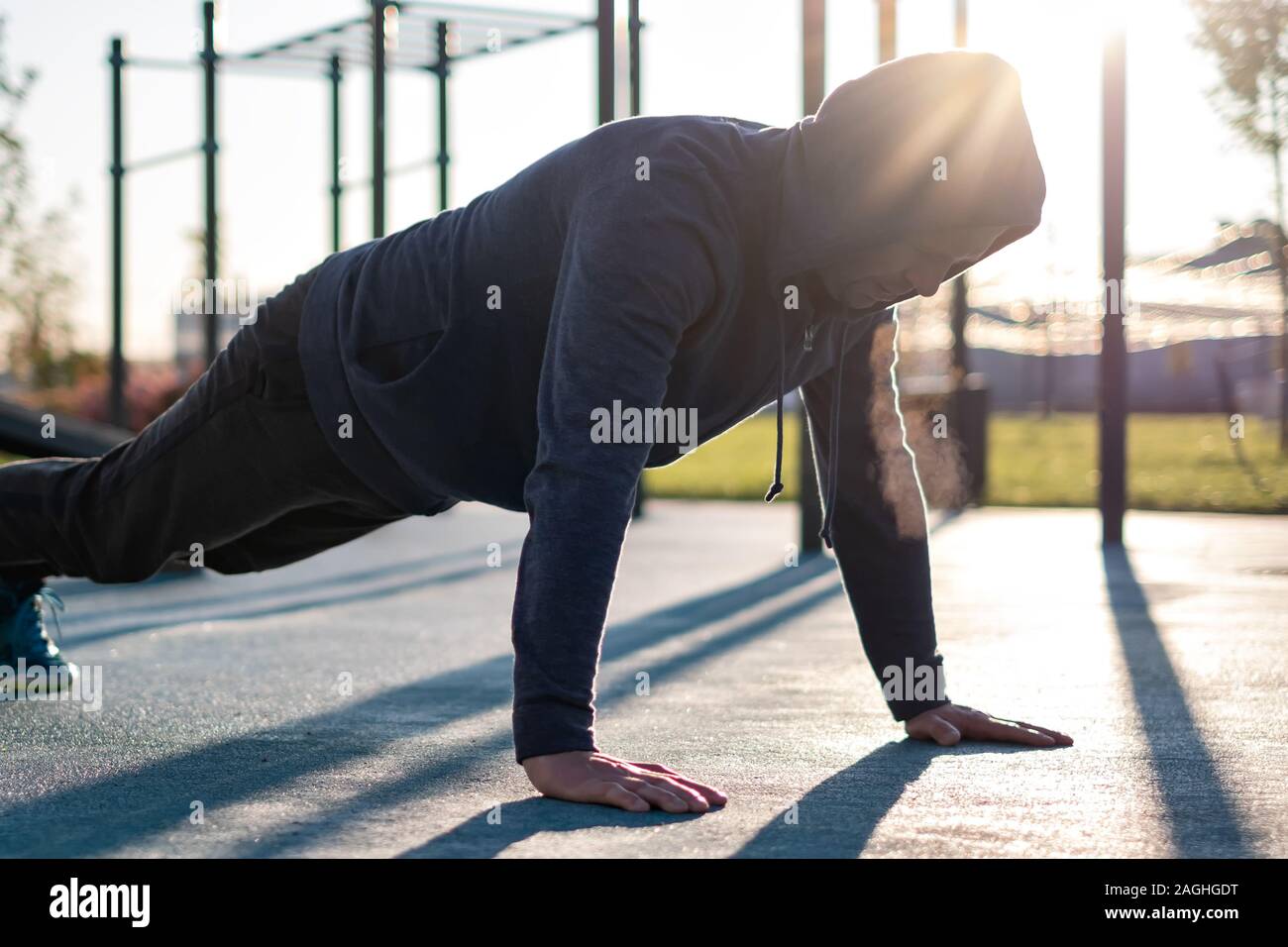 Sport, exercising, training concept. Young man doing push ups or plank exercise Stock Photo