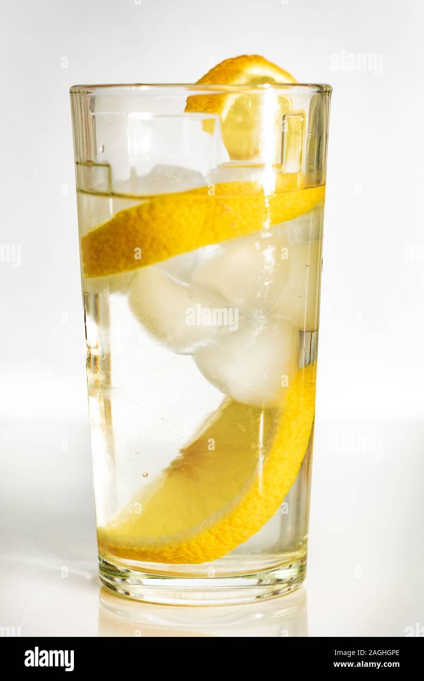 Glass of water with ice and slices of lemon on a white background Stock ...