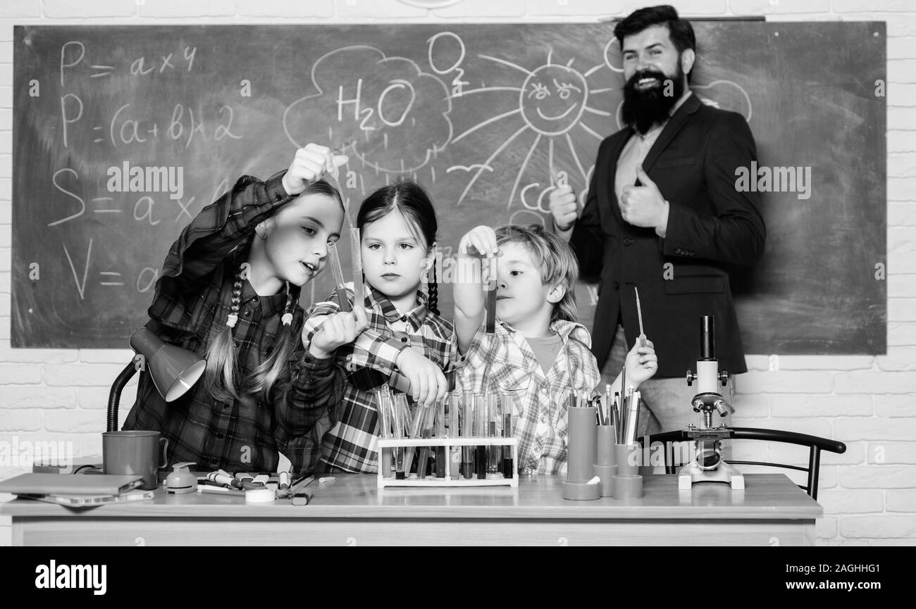 Little kids learning chemistry in school laboratory. school kids scientist studying science. happy children teacher. back to school. students doing sc Stock Photo