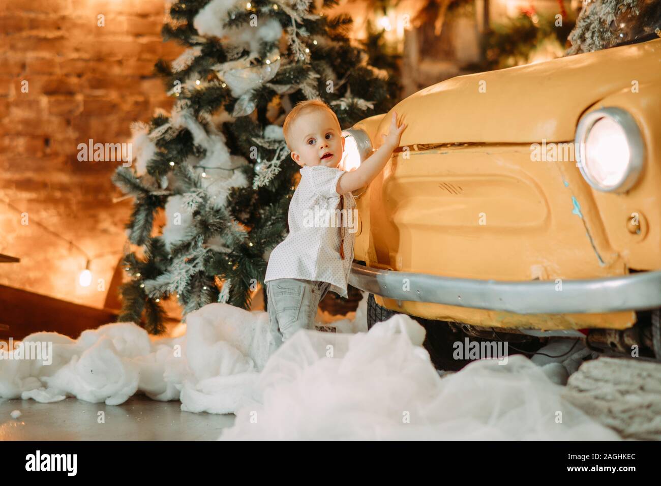 Little Boy Stands Next To Retro Car Against Background Of