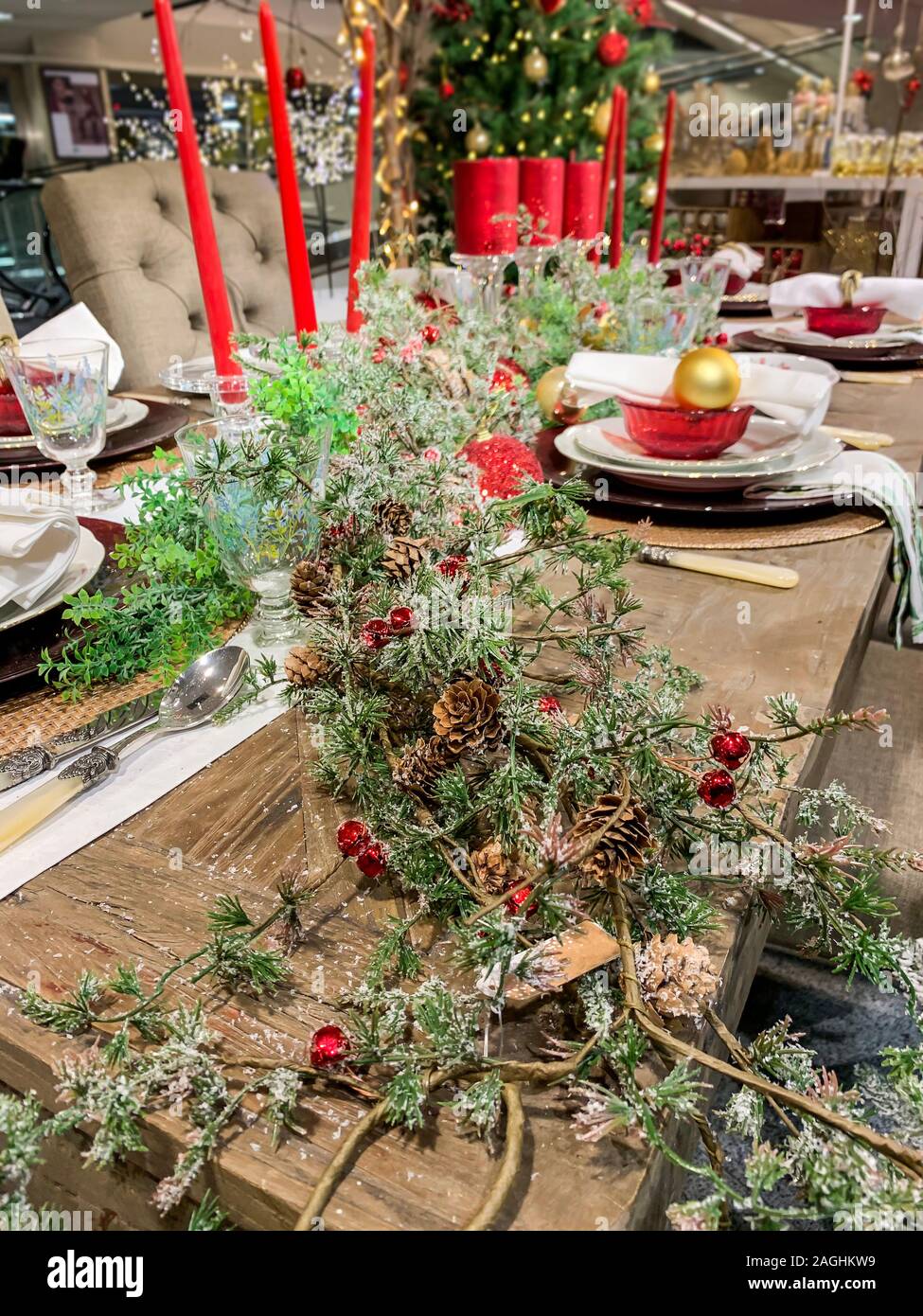 Elegant Christmas dinner table decoration, with dishes, glasses and ...