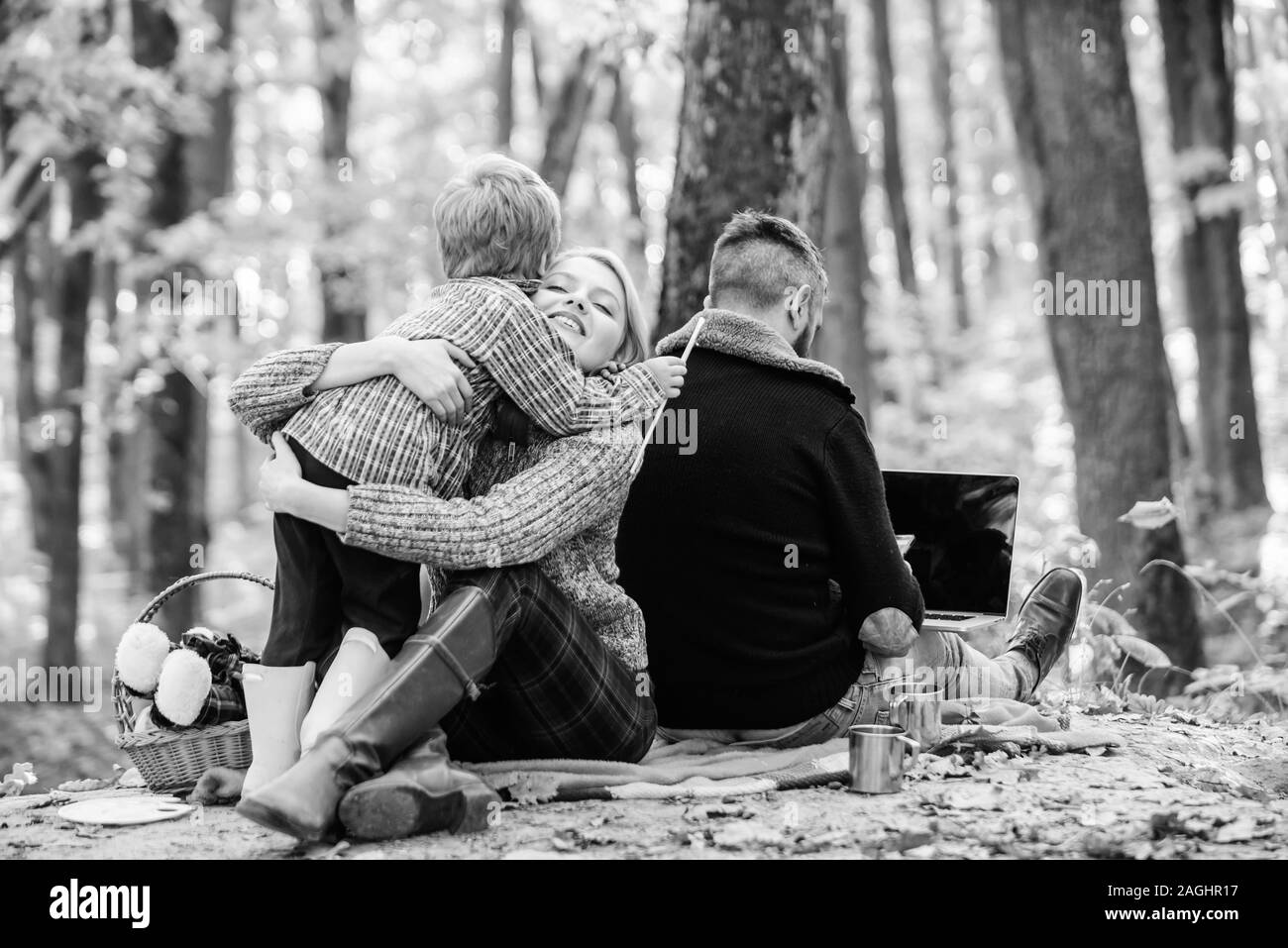 Happy son with parents relax in autumn forest. Mother, father love ...