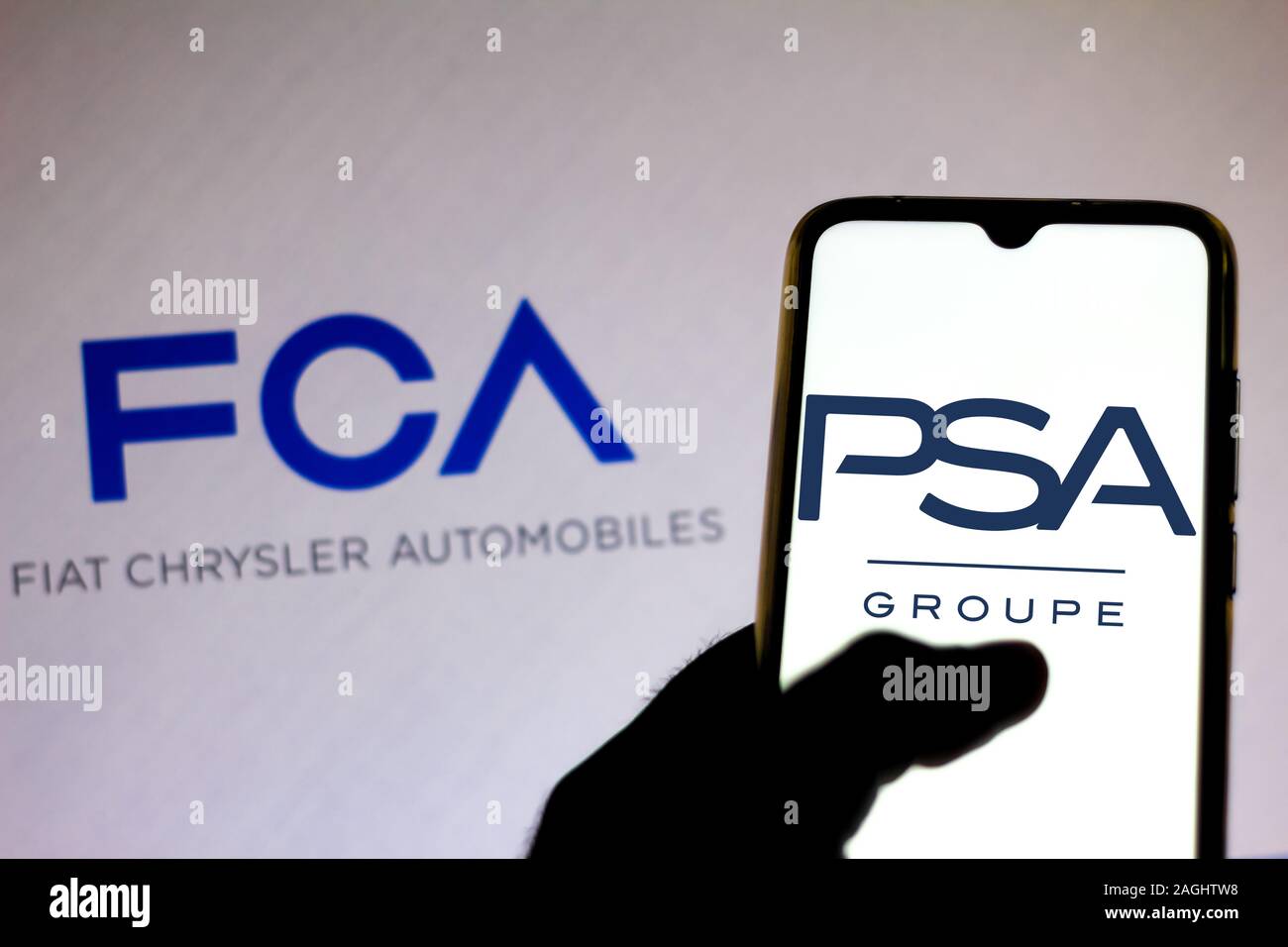 Brazil. 19th Dec, 2019. In this photo illustration the Groupe PSA logo is viewed on a smartphone and Fiat Chrysler Automobiles logo on a blurred background. Credit: Rafael Henrique/SOPA Images/ZUMA Wire/Alamy Live News Stock Photo