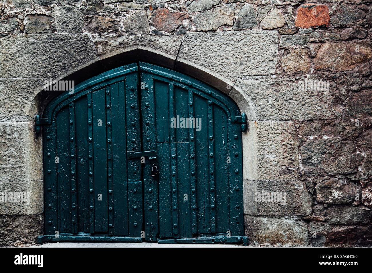 a large door in the old stone wall Stock Photo - Alamy