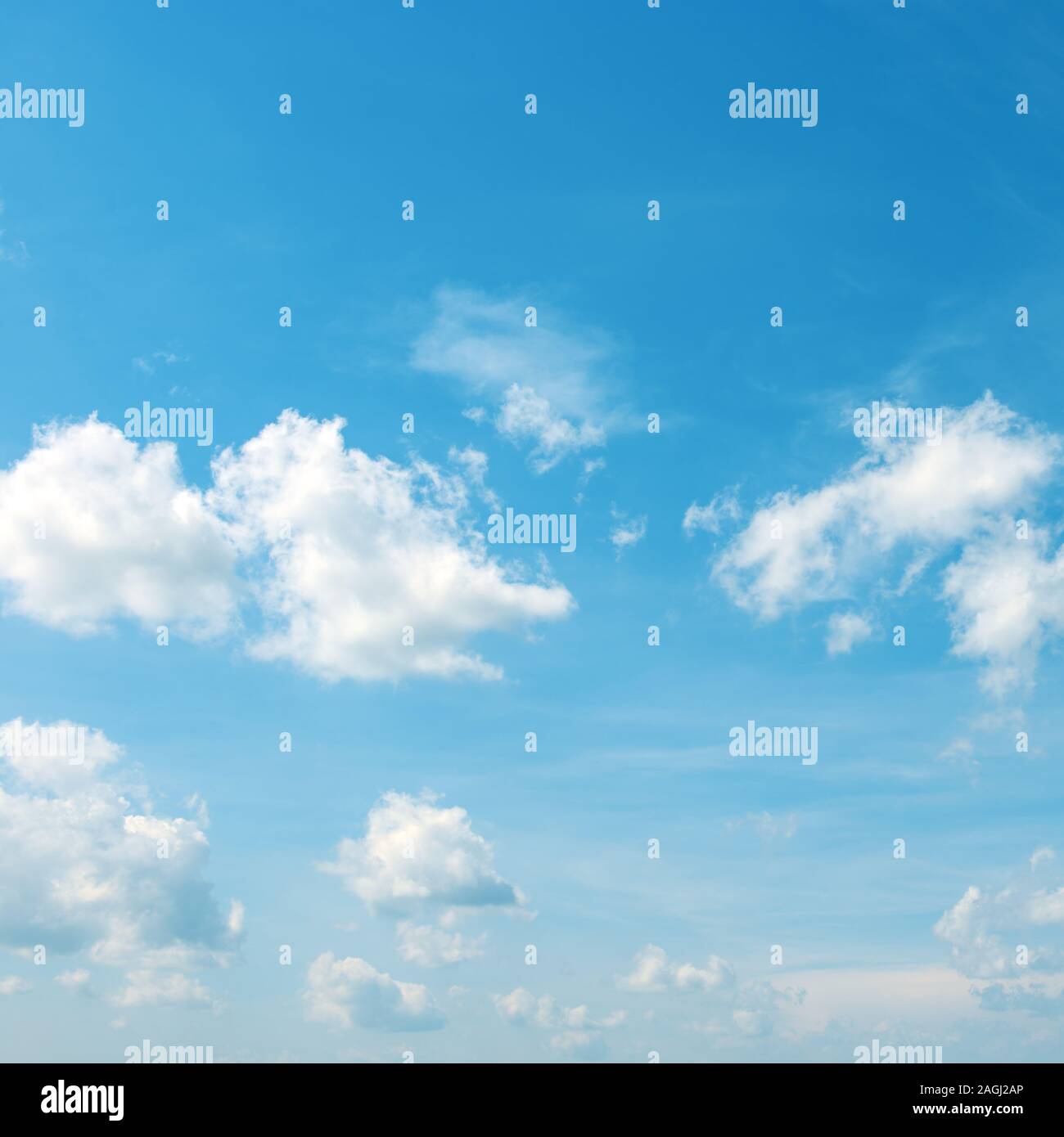 Heavenly landscape - white clouds in bright blue sky. Stock Photo