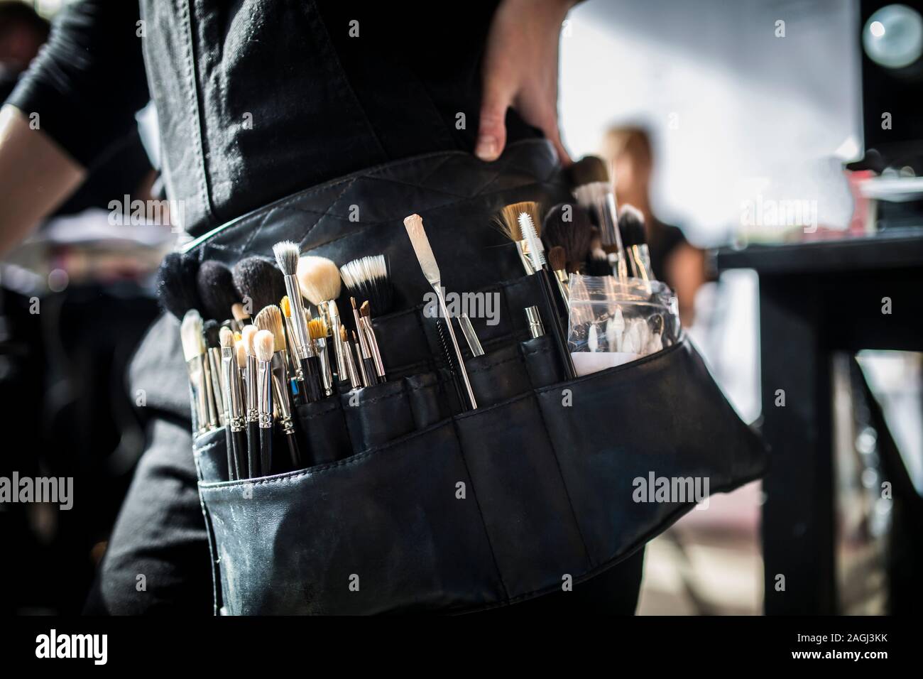 Close-up on a make-up artist's belt during the fashion show, backstage photo. Stock Photo