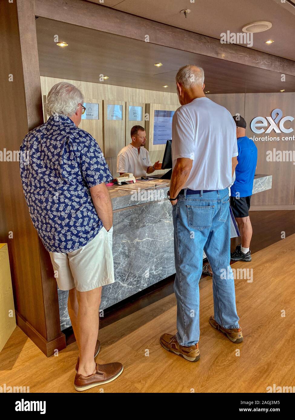 Ft. Lauderdale,FL/USA-11/1/19: Male passengers in line to inquire and purchase shore excursions from the crew of a Holland America Line cruise ship. Stock Photo