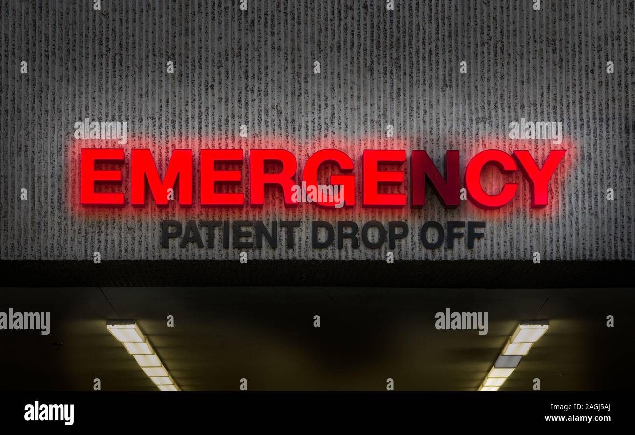 A Rundown Hospital Emergency Room Sign With Broken Light Stock Photo