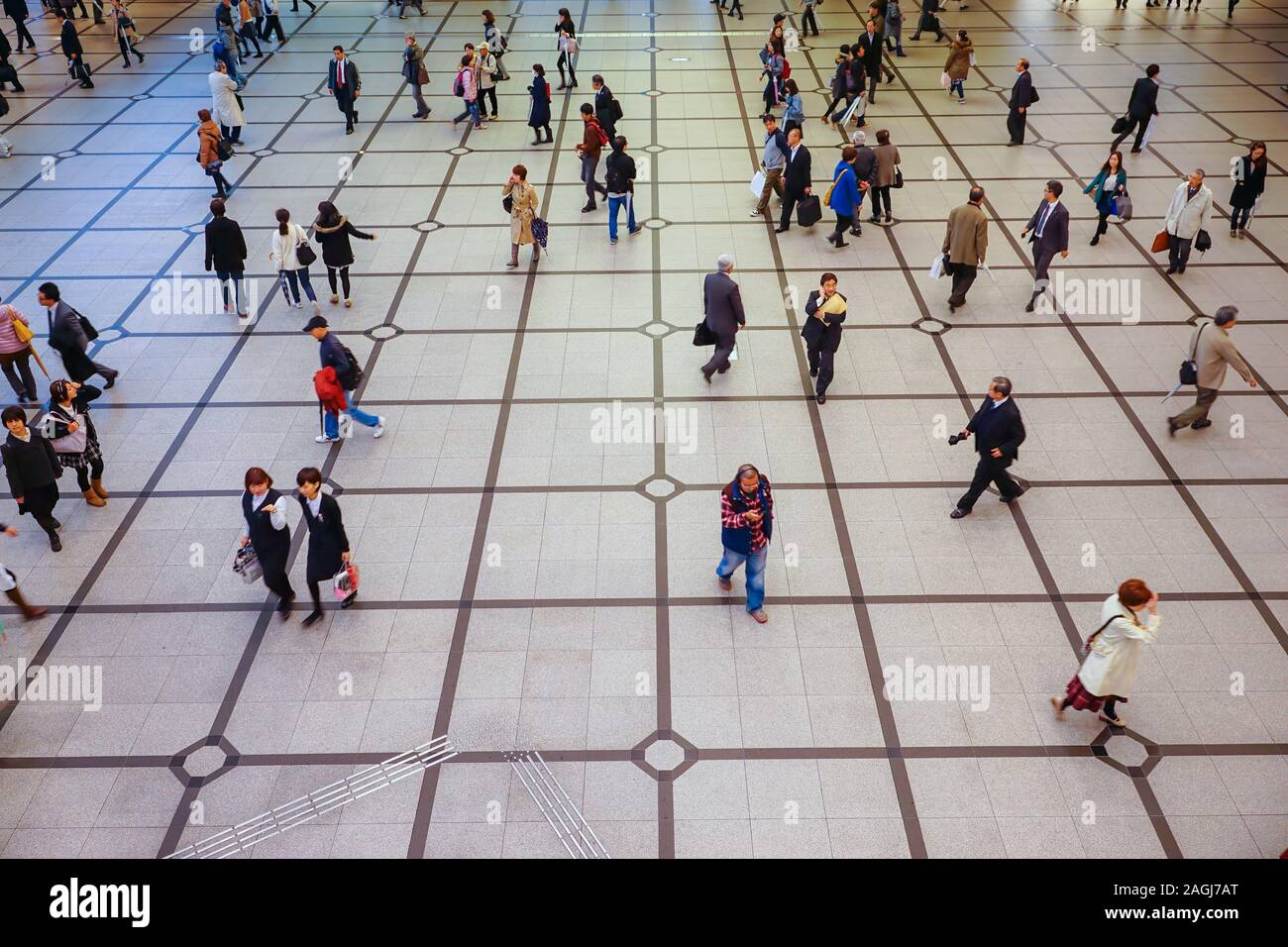 OSAKA, JAPAN - NOVEMBER 25, 2014: People walking under rain in a pedestrian crossing in Osaka, Japan. Stock Photo