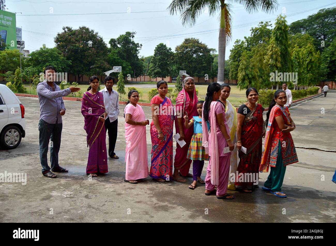 NAGPUR, INDIA - 15 OCT 2014: unidentified People queued in front of a polling station during Election Stock Photo