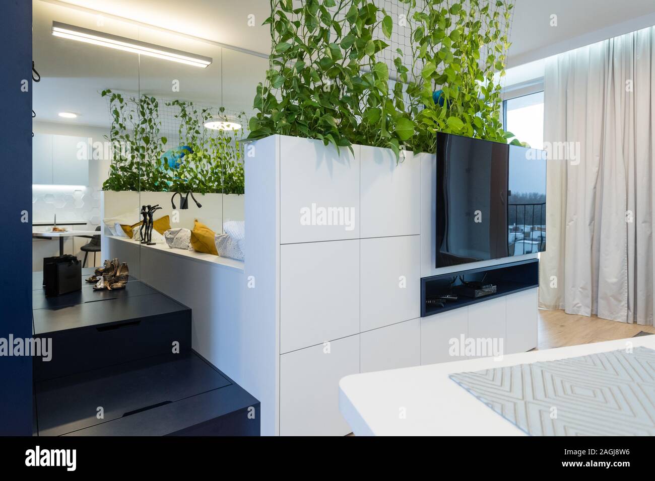 Interior Of Small Apartment Bedroom And Cabinet With Tv