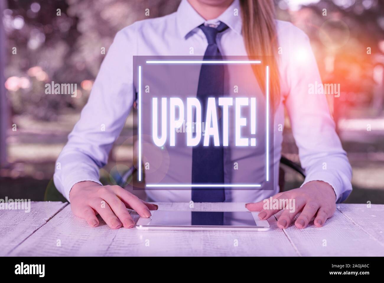 Text sign showing Update. Business photo text make something more modern or up to date like software program Female business person sitting by table a Stock Photo