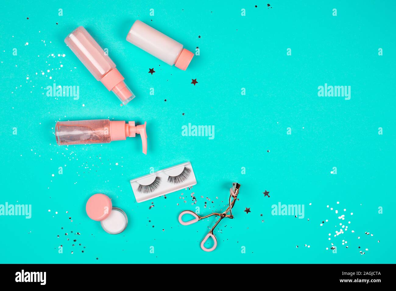 Care cosmetics on a trendy green background. Flat lay style. Stock Photo