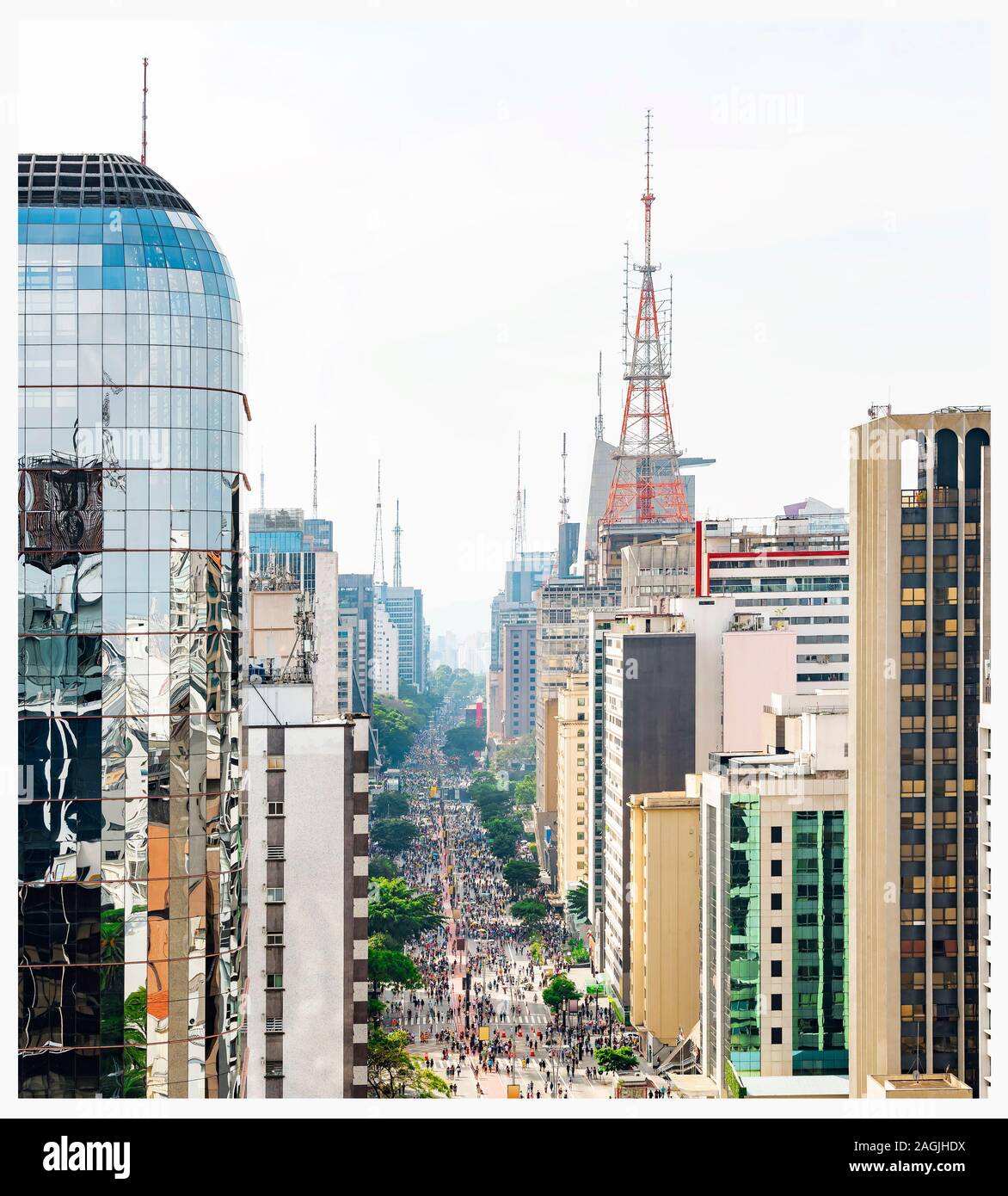 Aerial view of Paulista avenue full of people walking on the street and the tall buildings of the avenue. Commercial center at downtown of Sao Paulo S Stock Photo