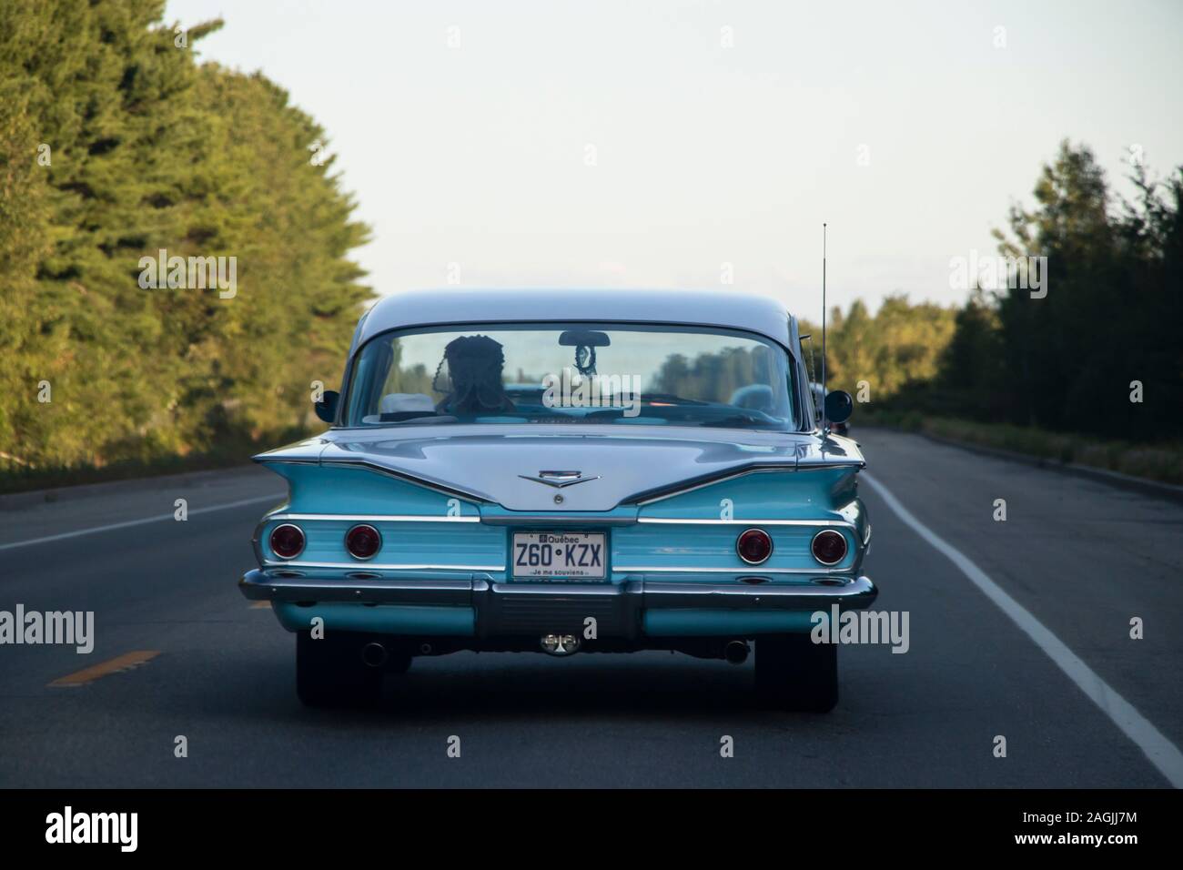 August 24, 2019 - Rte 343, QC: Rear View of Vintage Retro Buick Car and a woman driver on the Road after Kildare Deluxe Classic Car Exhibition Event Stock Photo
