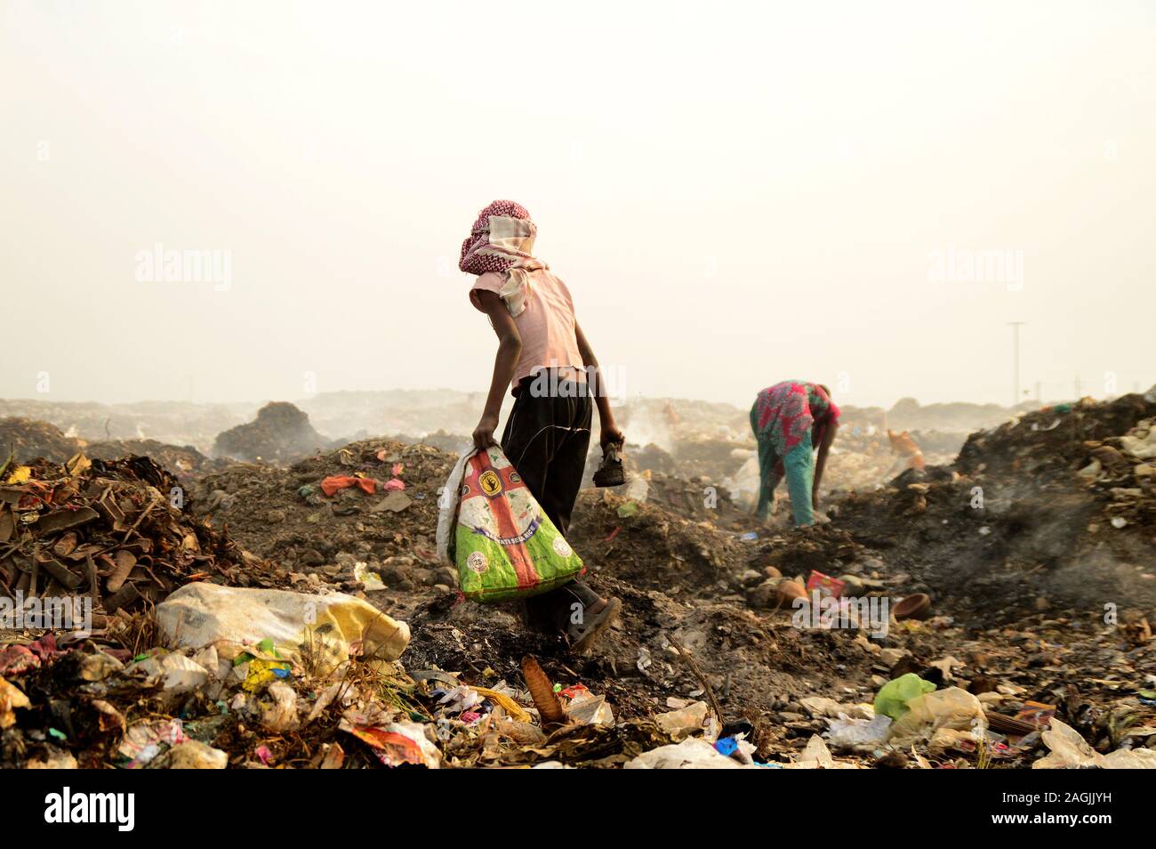 AMRAVATI, MAHARASHTRA, INDIA - APRIL 09, 2014: Unidentified rag pickers search for recyclable material in the garbage. Land and air pollution in India Stock Photo