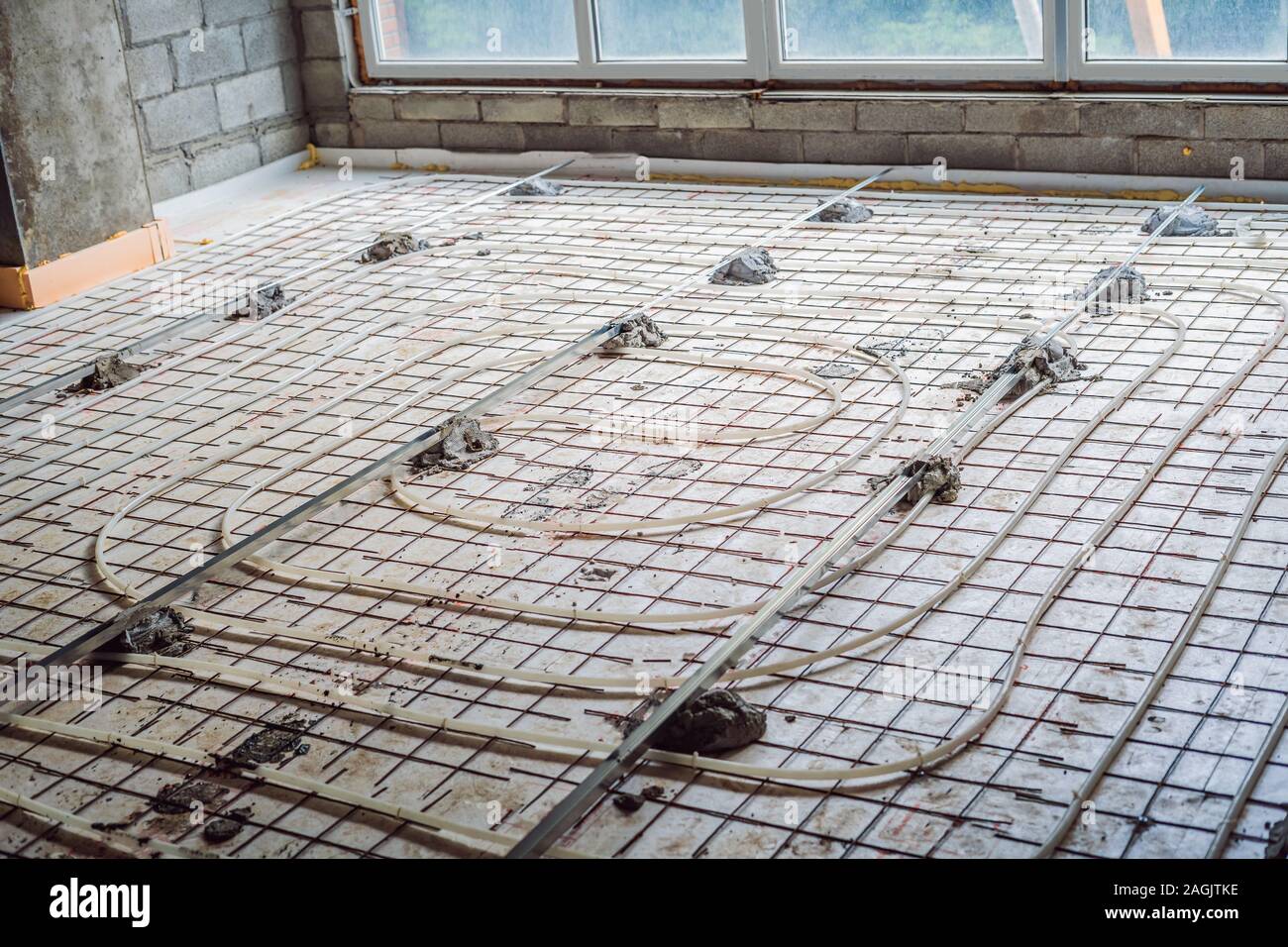 Pipe fitter mounted underfloor heating. Heating system and underfloor heating Stock Photo