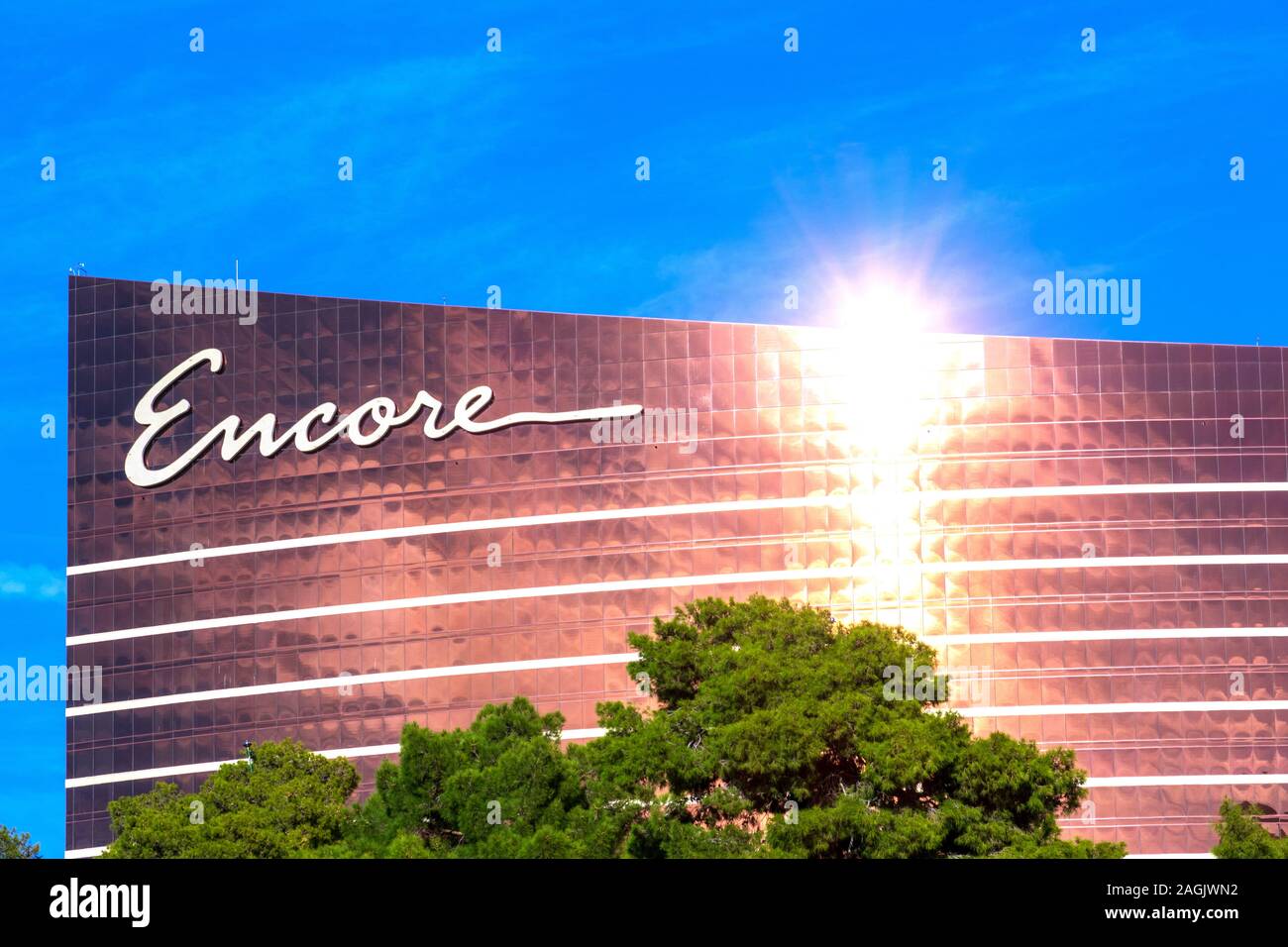 Bright sunlight reflects in the modern facade of Encore luxury hotel and casino as seen from Las Vegas Strip - Las Vegas, Nevada, USA - December, 2019 Stock Photo