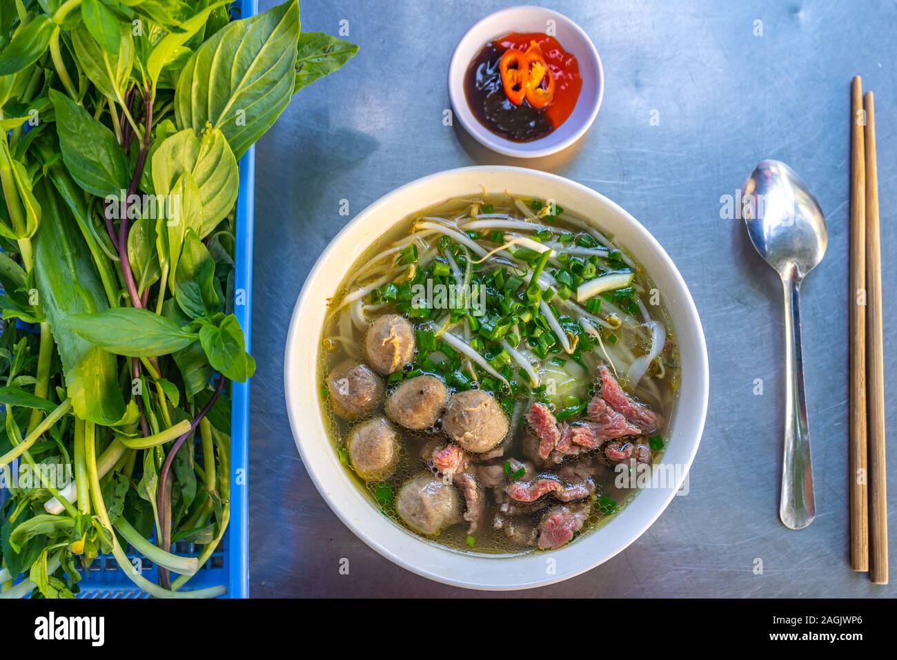 Garnished Vietnamese Pho bowl- beef noodle served with fresh vegetables Stock Photo