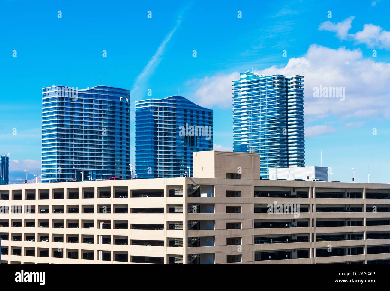 Multi level parking garage facade and exterior. Background high rise residential buildings. Stock Photo