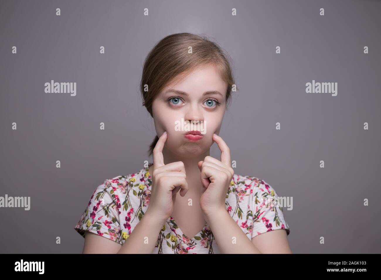 Young chubby caucasian woman girl with chubby cheeks Stock Photo