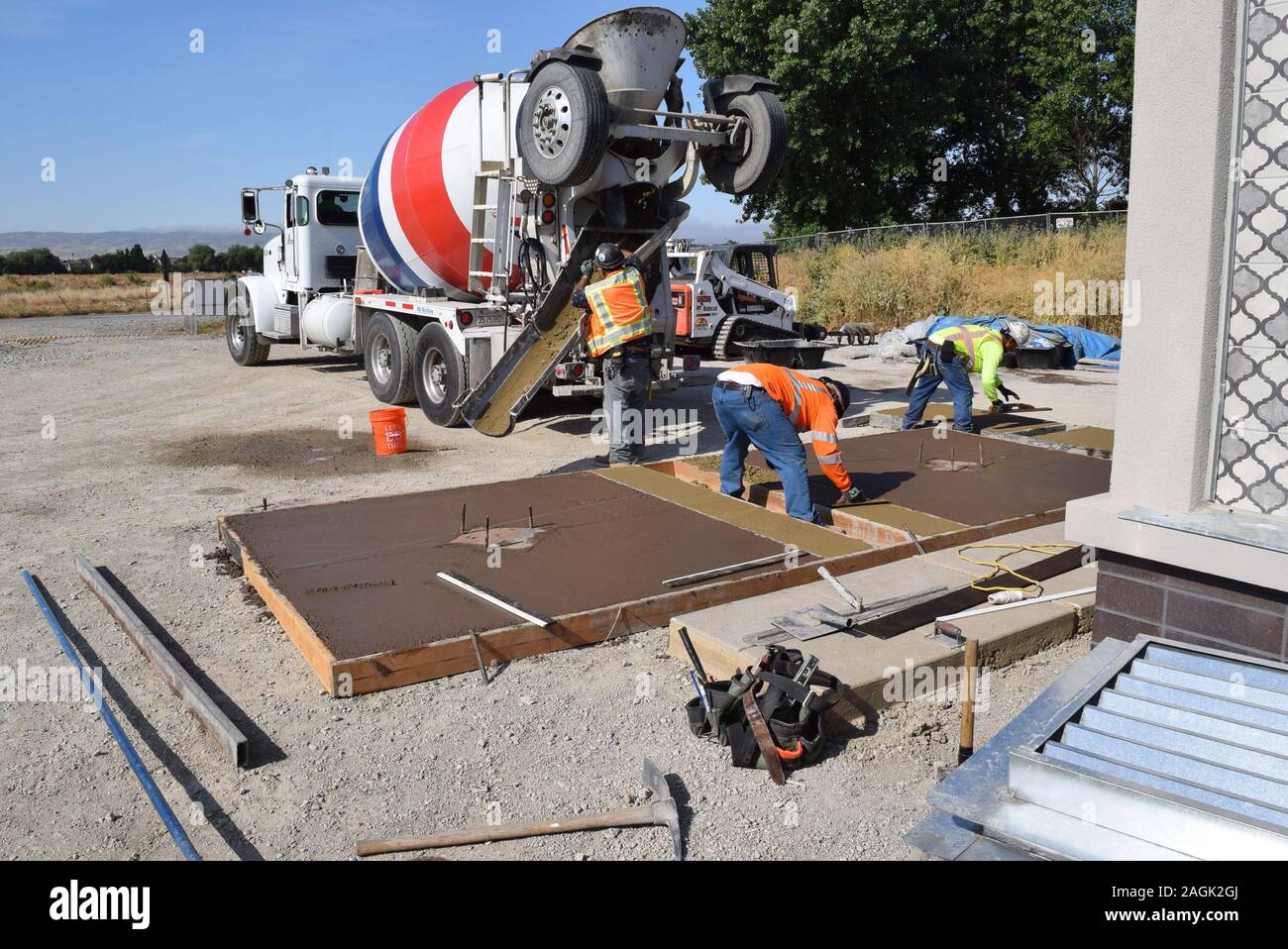 Construction workers laying a mock concrete slab to test. Stock Photo