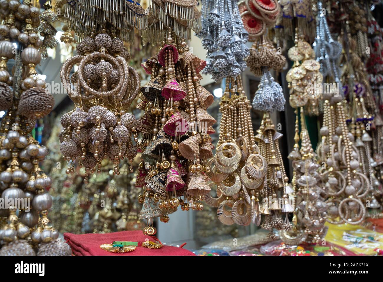 Colorful metallic decorations on display for sale in Chandi Chowk Old Delhi. These flowers, beads and bells designs are popular in weddings, festivals Stock Photo