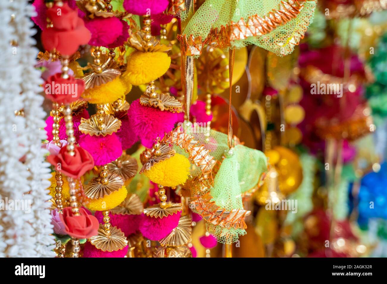Colorful fabric decorations on display for sale in Chandi Chowk Old Delhi. These flowers, beads and bells designs are popular in weddings, festivals a Stock Photo