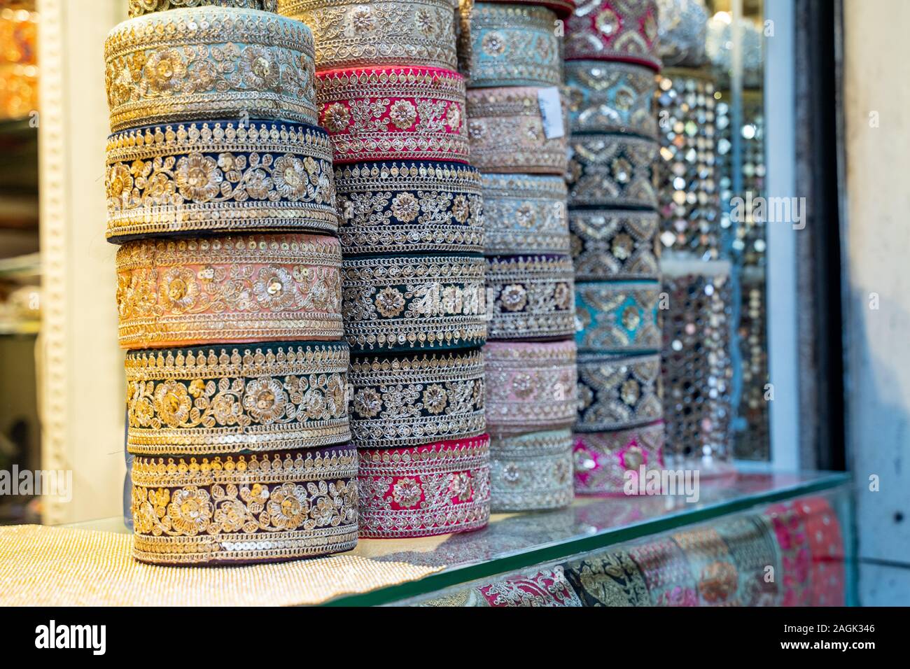 Colorful metallic brocade decorations on display for sale in Chandi Chowk Old Delhi. These flowers, beads and bells designs are popular in weddings, f Stock Photo