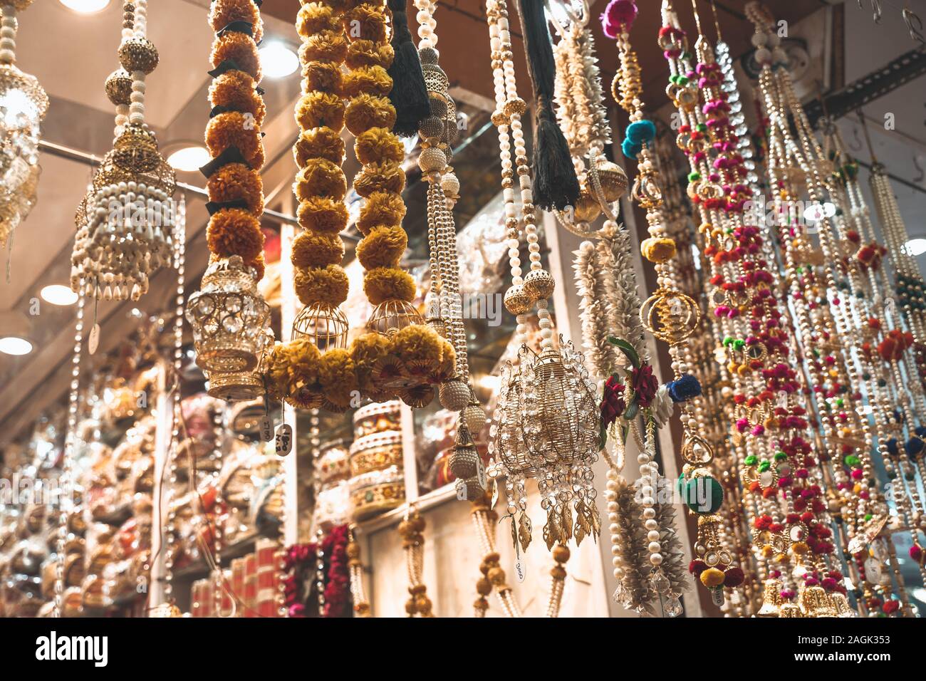 Colorful metallic decorations on display for sale in Chandi Chowk Old Delhi. These flowers, beads and bells designs are popular in weddings, festivals Stock Photo