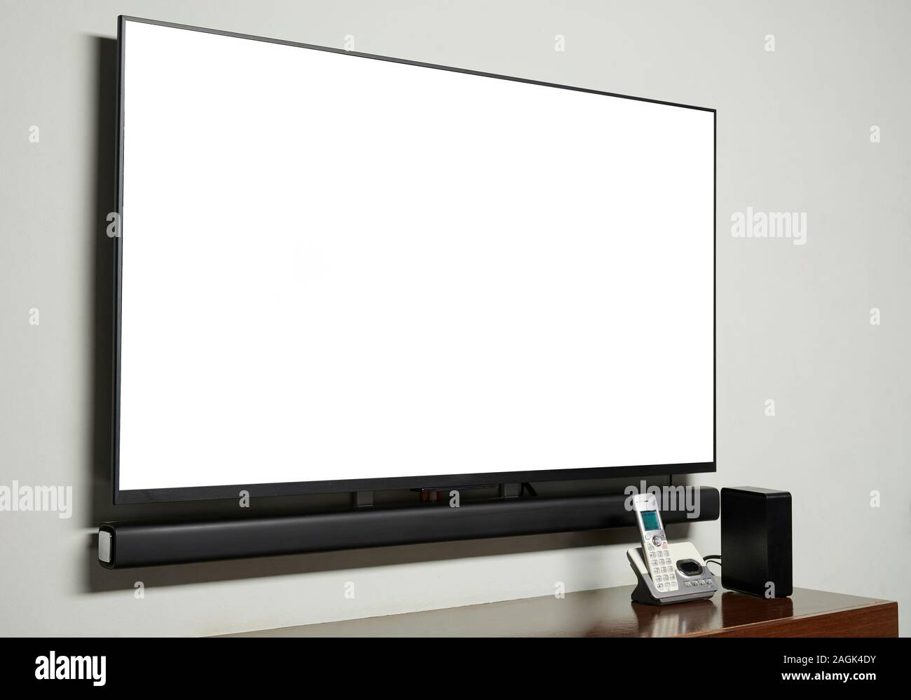 Set of electronics in living room. TV led panel, wifi modem with phone Stock Photo