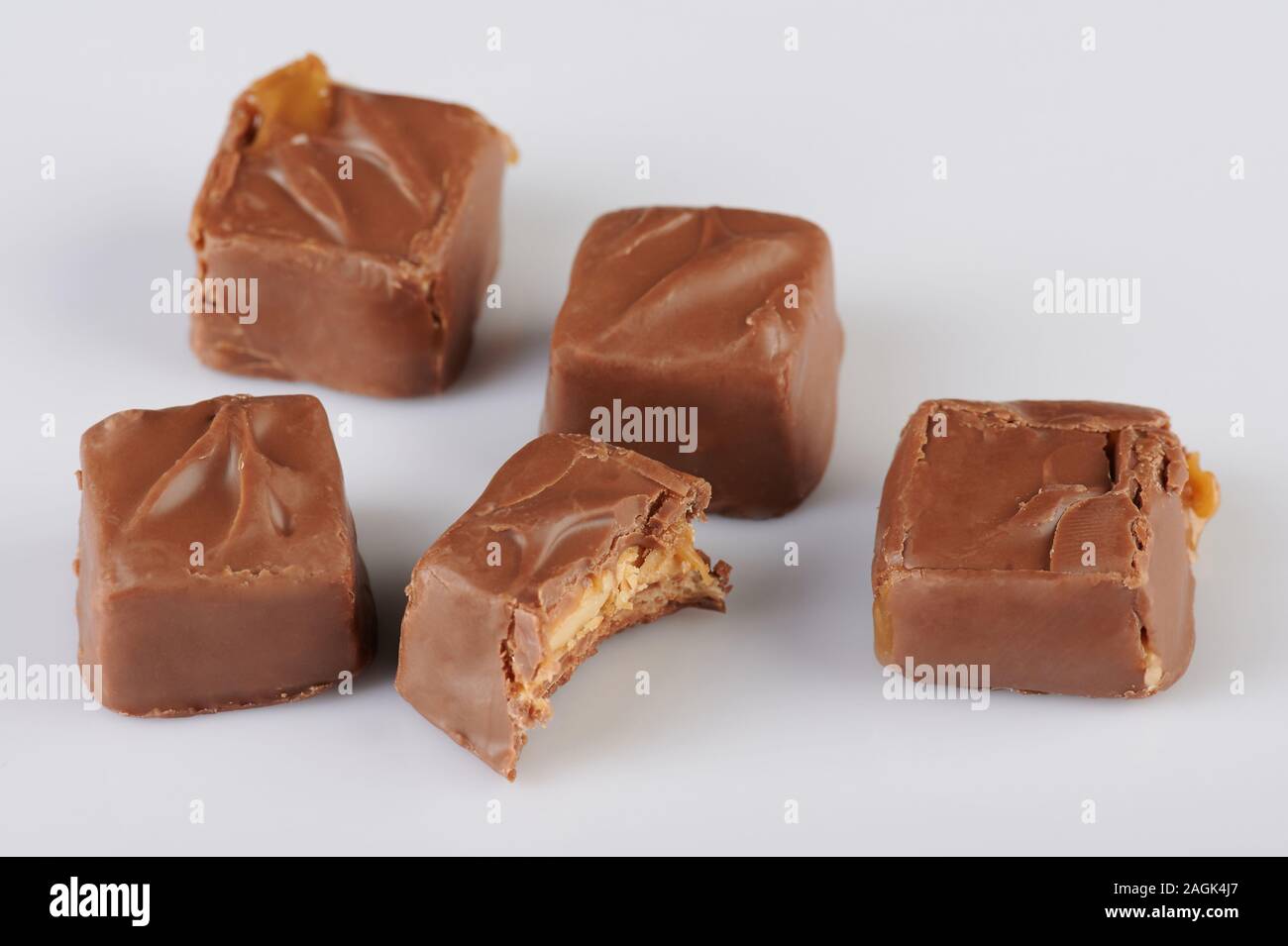 Milk chocolate caramel candy bars isolated on white background Stock Photo
