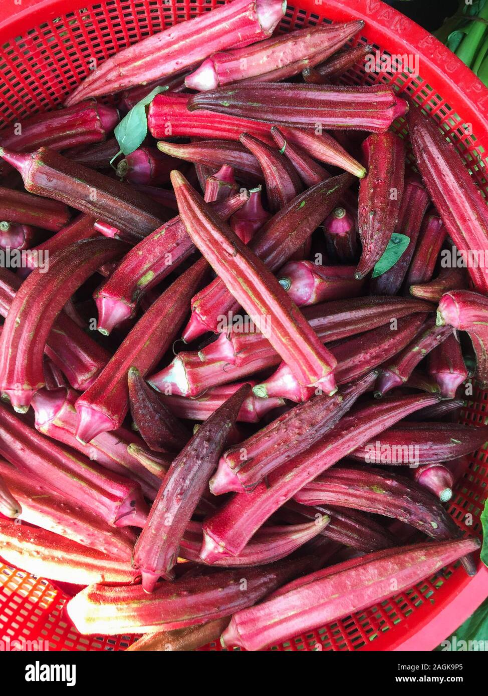 Red fresh okra for sale at local market in Saigon, Vietnam Stock Photo