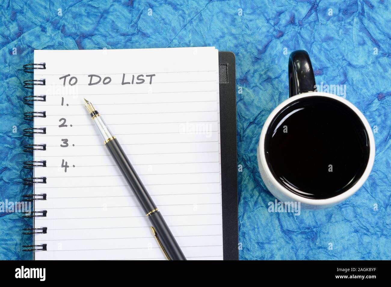 To Do List written on a book with pen and coffee cup Stock Photo