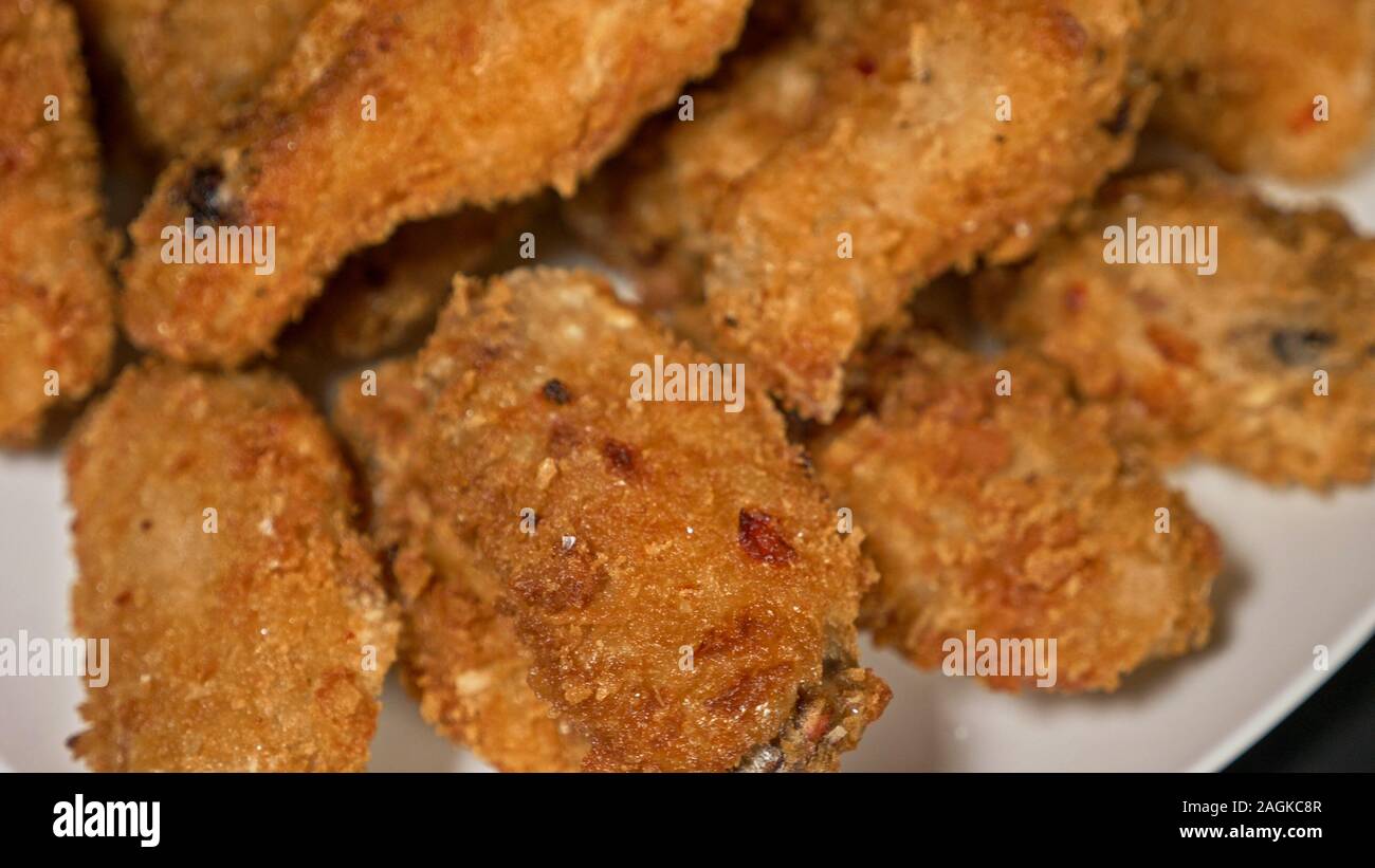 Cool beautiful fresh juicy cooked chicken wings in breading. Buffalo