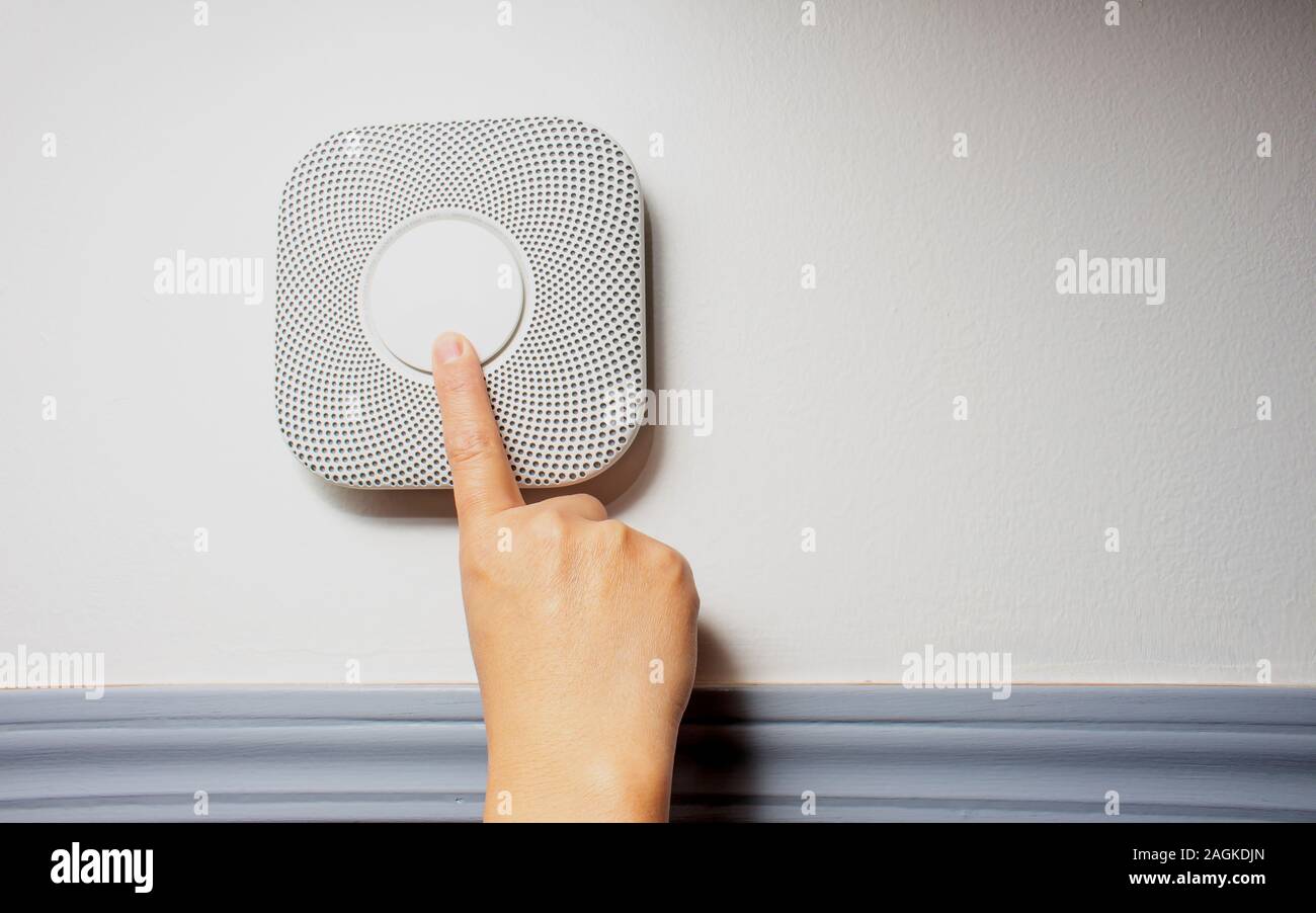 Smoke, fire and Carbon Monoxide Alarm being test with a soft shadow Stock Photo