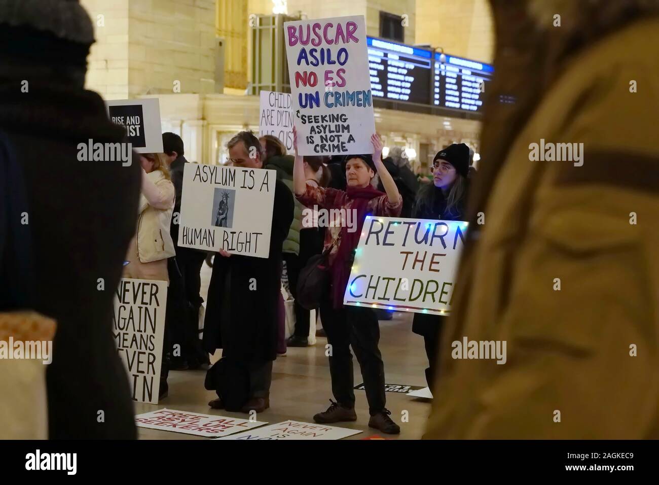 New York, NY / USA - December 19, 2019: Activists from the group Rise and Resist NYC holds up a banner and looks on stoically during a silent protest Stock Photo