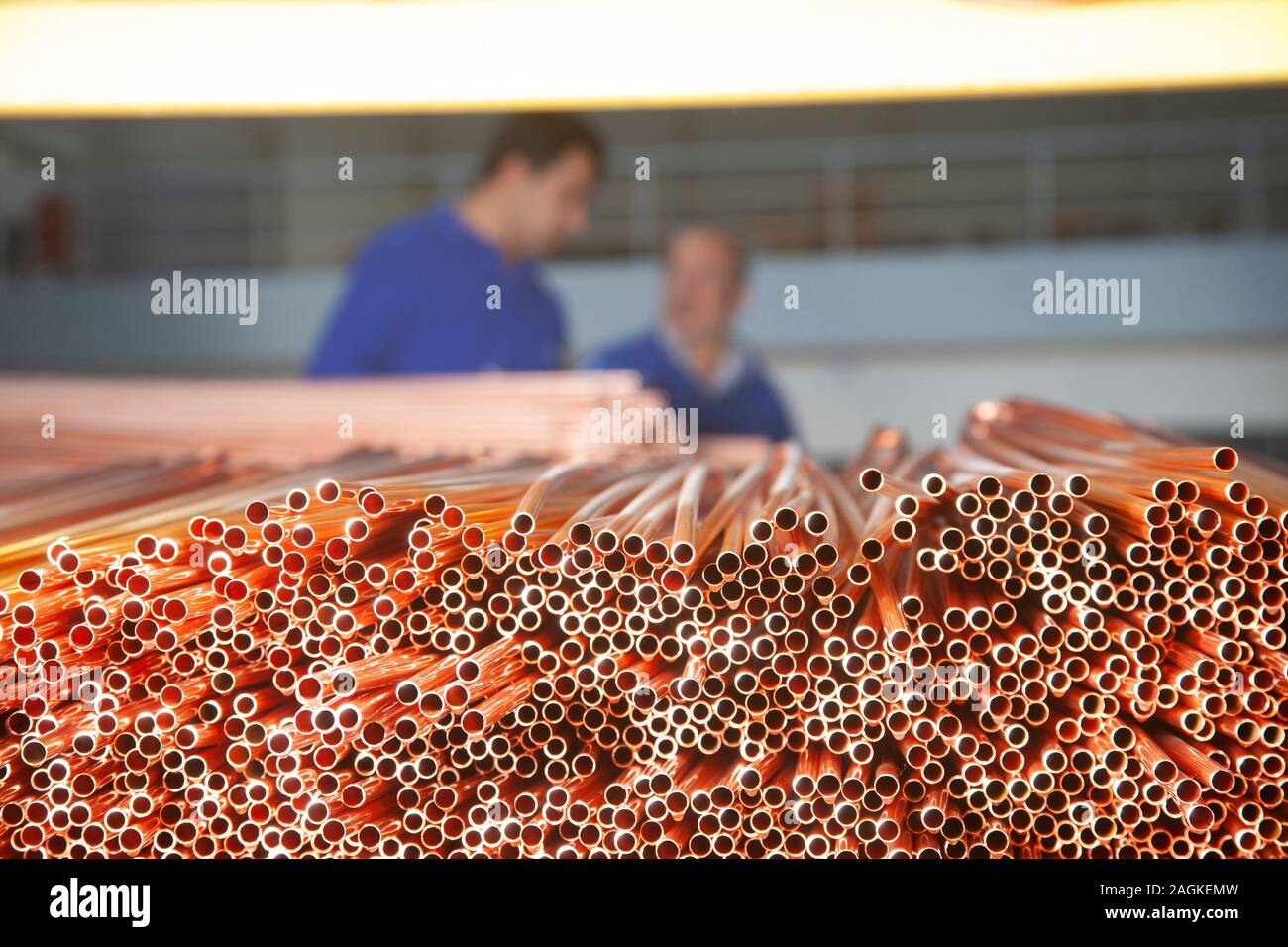 Copper pipes in factory, industrial background. Metal workers in ...